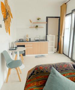 a room with a bed and a table and a kitchen at Pakuhaji Highland Ecoresort in Panjadakan