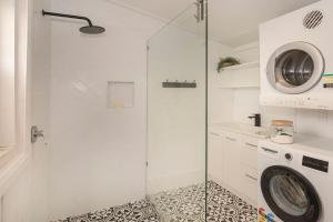 a bathroom with a shower and a washing machine at Busselton Central Accommodation in Busselton +19 photos