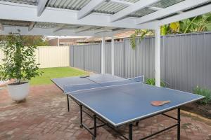 a ping pong table sitting on a patio at Busselton Central Accommodation in Busselton