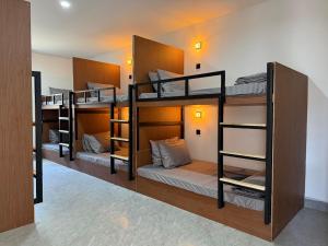 a group of bunk beds in a room at Sand and Sun Koh Rong in Kaôh Rŭng