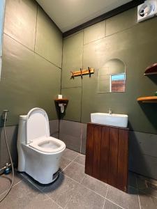 a bathroom with a toilet and a sink at Sand and Sun Koh Rong in Kaôh Rŭng