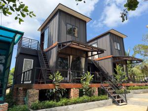a house with two floors and a staircase leading up to it at Sand and Sun Koh Rong in Kaôh Rŭng