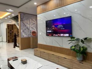 a lobby with a large flat screen tv on a wall at Bắp Villa Huế in Thôn Lại Thê