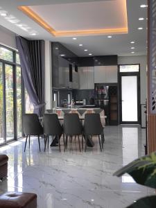 a kitchen with a table and chairs in a room at Bắp Villa Huế in Thôn Lại Thê