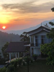 a house with the sunset in the background at Smart heritage in Galaha Town +12 photos