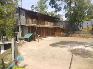 a man standing in front of a house at Smart heritage in Galaha Town