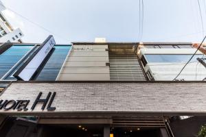 a building with a sign on the top of it at Hotel HL in Seoul