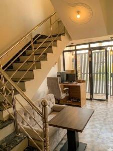 a living room with a staircase with a desk at Baloonrooms in Gorakhpur
