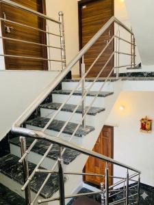 a staircase in a house with a metal railing at Baloonrooms in Gorakhpur +6 photos