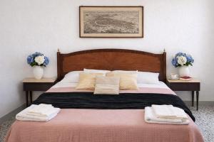 a bedroom with a large bed with towels on it at Iris Peaceful Apartment near Lake Como and Lugano in Lanzo dʼIntelvi