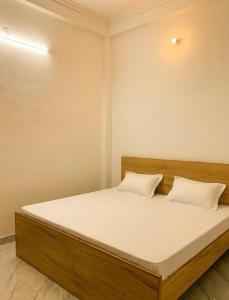 a bed with two pillows on it in a room at Privyrooms Taramandal in Gorakhpur