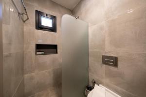 a bathroom with a shower and a window in it at Orkide Bodrum in Bodrum City +37 photos