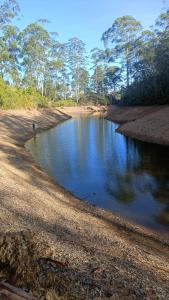 a small body of water with a person standing in it at Meneth Villa in Hatton
