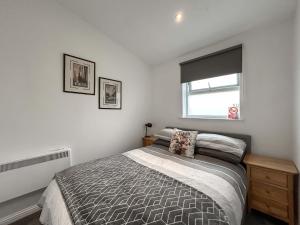 a bedroom with a bed and a window at Peebles Apartment in Peebles