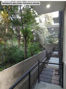 a set of stairs leading to a balcony with trees at Hillside Home in Kundasale