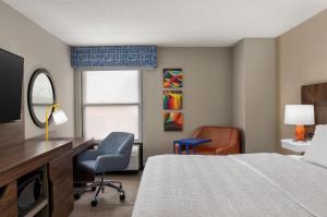 a hotel room with a bed and a desk and chair at Hampton Inn Eden in Eden +36 photos