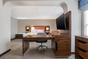 a hotel room with a desk and a bed at Hampton Inn Eden in Eden