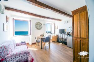 a living room with a couch and a table at La cabina del capitano in Bogliasco