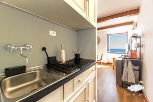 a kitchen with a sink and a counter top at La cabina del capitano in Bogliasco