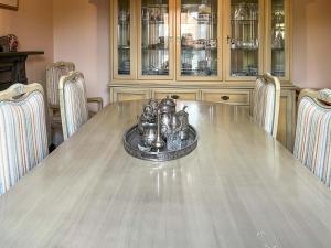 a dining room with a table with chairs and china cabinets at Embleton House - Uk51597 in Berwick-Upon-Tweed