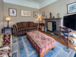 a living room with a couch and a fireplace at Embleton House - Uk51597 in Berwick-Upon-Tweed