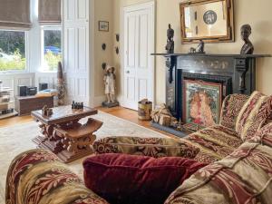 a living room with a couch and a fireplace at Embleton House - Uk51597 in Berwick-Upon-Tweed
