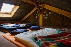 a room with three beds in a attic at Blickinsfreie - Cabin in Schöneck +75 photos