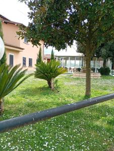 a fence in front of a building with trees and flowers at beds ar colle 2 in Valmontone