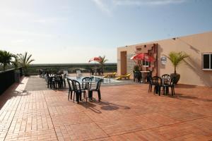 d'une terrasse avec des tables et des chaises sur un sol en briques. dans l'établissement Hotel Delta, à Parnaíba