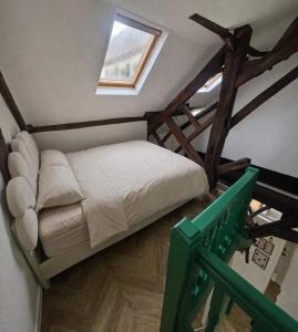 a small bed in a room with a window at La Cathedrale in Senlis