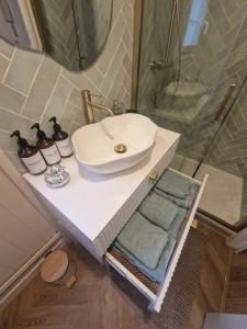 a bathroom with a sink and a mirror at La Cathedrale in Senlis +3 photos