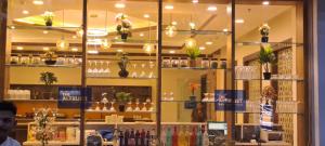 a store window with vases and plants on shelves at The Altruist Navi Mumbai Hotel in Navi Mumbai +67 photos