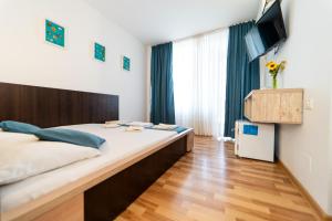 a bedroom with a large bed and a television at Complex Marinn Costinesti in Costinesti +144 photos