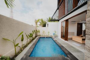 a swimming pool in the backyard of a house at The Solas Villa Ubud in Ubud
