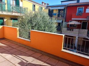 an orange fence in a courtyard of a building at Corte DON BOSCO 5 in Monfalcone +5 photos