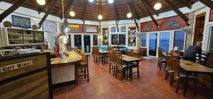 a bar with wooden tables and chairs in a restaurant at Punta Private Beach Resort in San Teodoro