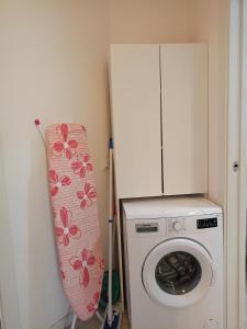 a kitchen with a washing machine and a refrigerator at Corte DON BOSCO 5 in Monfalcone