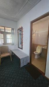 a room with a bathroom with a toilet and a sink at Aurora Residence Nuwara Eliya in Nuwara Eliya