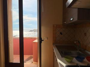 a kitchen with a sink and a view of the ocean at Tra Mare e Relax in Gallipoli +65 photos