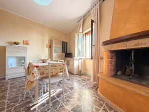 a living room with a table and a fireplace at Tra Mare e Relax in Gallipoli