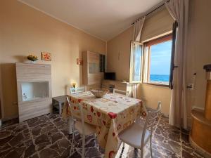 a dining room with a table and a window at Tra Mare e Relax in Gallipoli