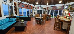 a living room with a blue couch and a bar at Punta Private Beach Resort in San Teodoro
