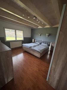 a bedroom with a large bed in a room at Black Forest Sports Loft in Achern
