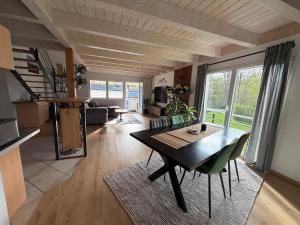 a living room with a table and chairs in a room at Black Forest Sports Loft in Achern