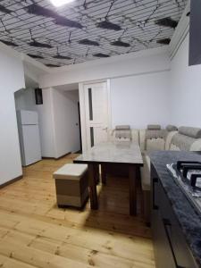 a room with a table and chairs and a kitchen at BridgeStayHostel in Samarkand