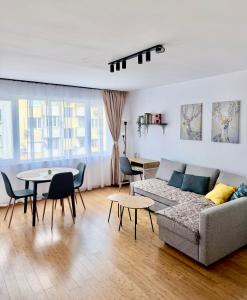 a living room with a couch and a table at Shazam Apartment Central, Stylish & Cozy near AUBG in Blagoevgrad