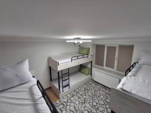 a small room with two beds and a desk at BridgeStayHostel in Samarkand