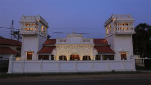 a large white building with two towers at Monsoon Villa in Puttalam