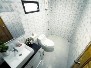 a bathroom with a white toilet and a sink at De Napa - Private Homestay in Ban Mae Na +34 photos
