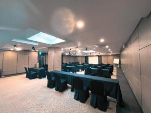 a conference room with blue tables and black chairs at Hotel Atrium Jongno in Seoul
